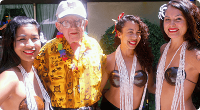 Senior man with dancers at a festive event.