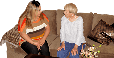 Resident and staff member engaged in conversation.