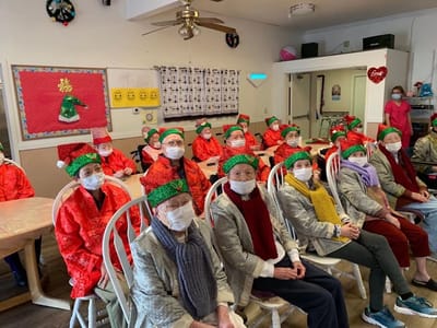 Residents participating in a festive event wearing holiday attire.