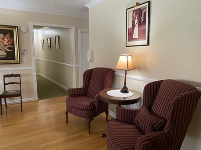 Cozy common area with chairs and artwork.