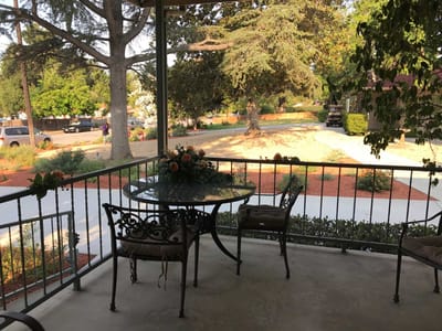 Outdoor patio area with a view of gardens.