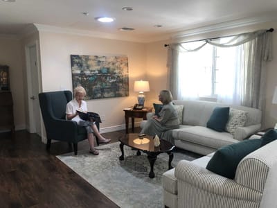Residents socializing in a cozy living room area.