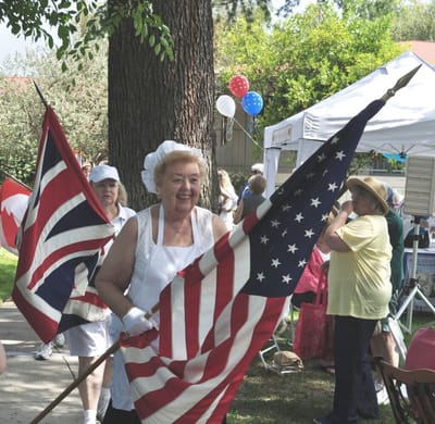 Residents celebrating with flags outdoors