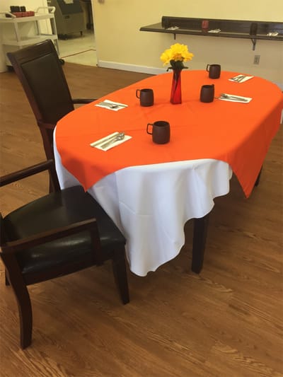 Table set for dining with orange tablecloth