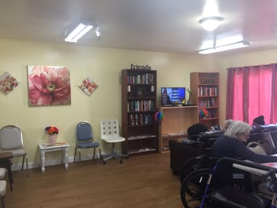 Interior common area with residents and bookshelves