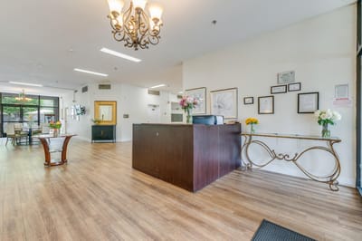 Welcoming lobby area with reception desk and floral arrangements.