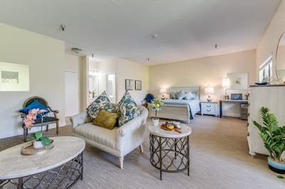 Bright, welcoming resident room with comfortable furnishings.