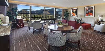 Bright common area with seating and mountain view.
