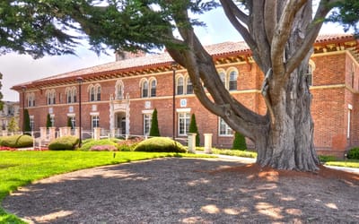 Exterior view of a brick building surrounded by landscaping.