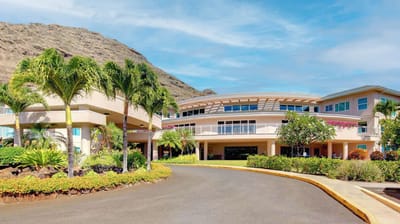 Exterior view of assisted living facility with landscaping.