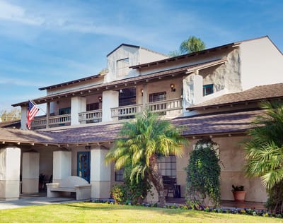 Exterior view of a nursing home with palm trees