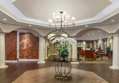 Welcoming lobby with floral arrangement and seating area.