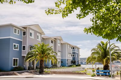 Exterior view of a nursing facility with palm trees