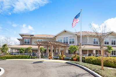 Exterior view of assisted living facility with landscaping.
