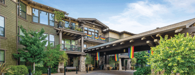 Exterior view of The Ivy at Blue Oaks with colorful flags.