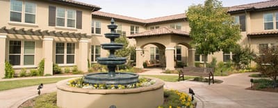 Outdoor space with a fountain and seating area.