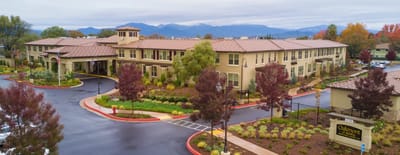 Exterior view of assisted living facility with landscaping.