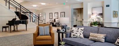 Elegant common area with seating and a piano.