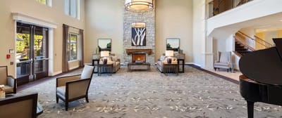 Spacious lobby area with comfortable seating and fireplace.
