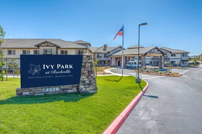 Exterior view of assisted living facility with sign
