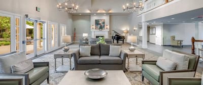 Cozy common area with seating and piano.