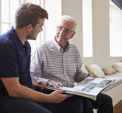 Senior resident sharing memories with a caregiver.