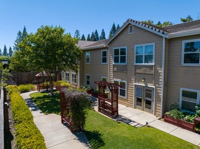 Exterior view of the facility with landscaped outdoor space.
