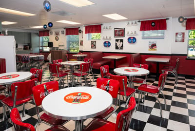 Vibrant dining area with red booths and tables