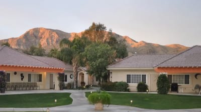 Scenic view of facility buildings with mountains in background.