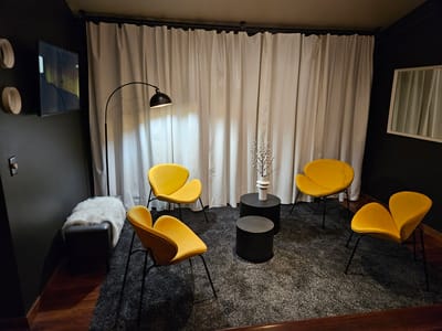 Cozy seating area with yellow chairs and a modern lamp