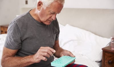 Senior man managing medication