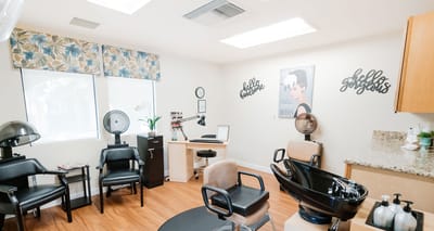 Salon area with hair styling stations and equipment.