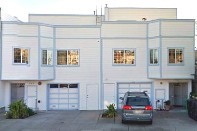 Exterior view of a building with a vehicle parked.