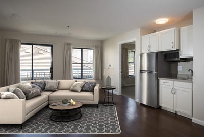 Bright, inviting resident living room with a sofa.