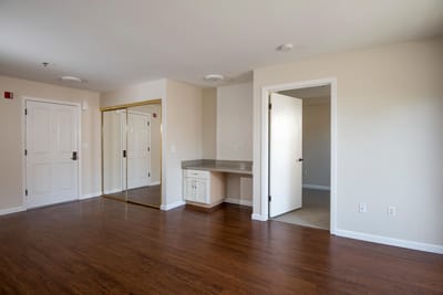 Empty resident room with natural light and decor