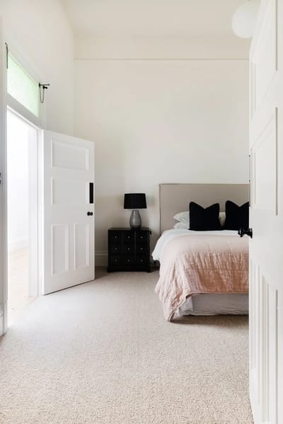 Cozy bedroom with light colors and soft textures.