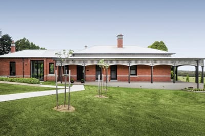 Exterior view of a residential facility with green lawn.