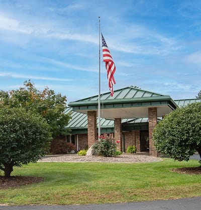 Front entrance of Valley Pines facility with flag.