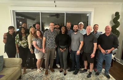 Group of staff members posing in a common area.
