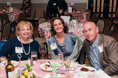 Three residents enjoying a meal at an event.