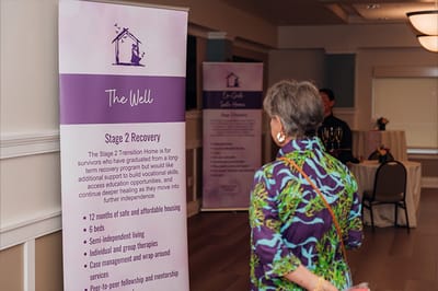 Resident engaging with informational displays in a common area.