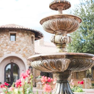A decorative fountain surrounded by flowers