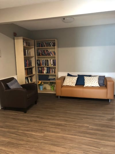 Cozy common area with seating and bookshelves