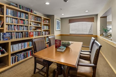 Cozy library area with books and a table.