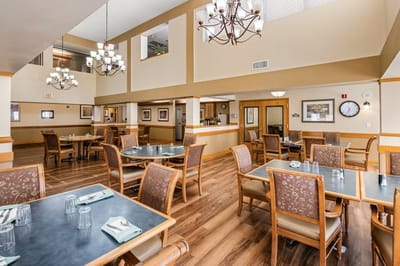 Dining area with wooden tables and chairs.