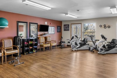 Exercise area with fitness equipment and weights.