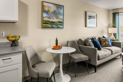 Cozy lounge area with seating and artwork.
