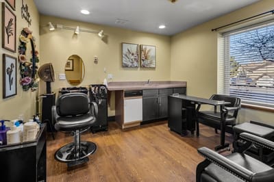Interior view of a salon area with styling chairs and decorations.