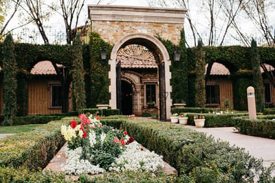 Beautiful exterior entrance with flowers and greenery