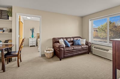 Cozy interior of a resident's room with a sofa and decor.